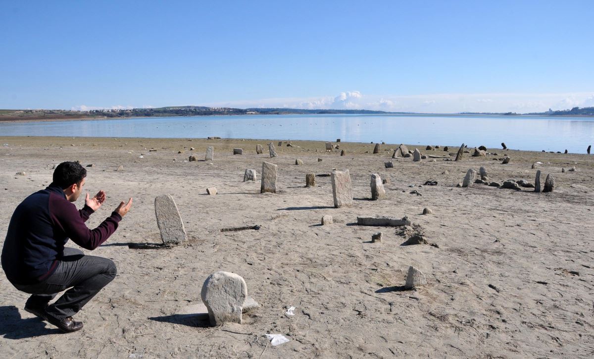 Su altında kalan mezarlığa sandalla giderek dua ediyorlar