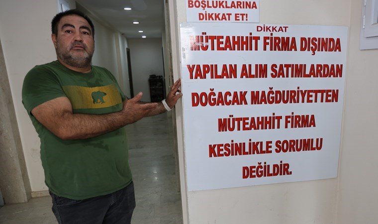 'Dolandırıldım' diyerek önce dairenin kapısını betonla kapattı, sonra 'afişli' tepki gösterdi