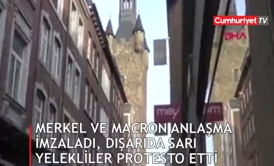 İçeride Merkel ve Macron anlaşma imzaladı, dışarıda sarı yelekliler protesto etti